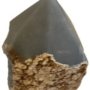 Natural rough angelite freeform with polished point 2 sians emporium Natural rough angelite freeform crystal with unpolished sides and a smooth polished blue point standing on a white background